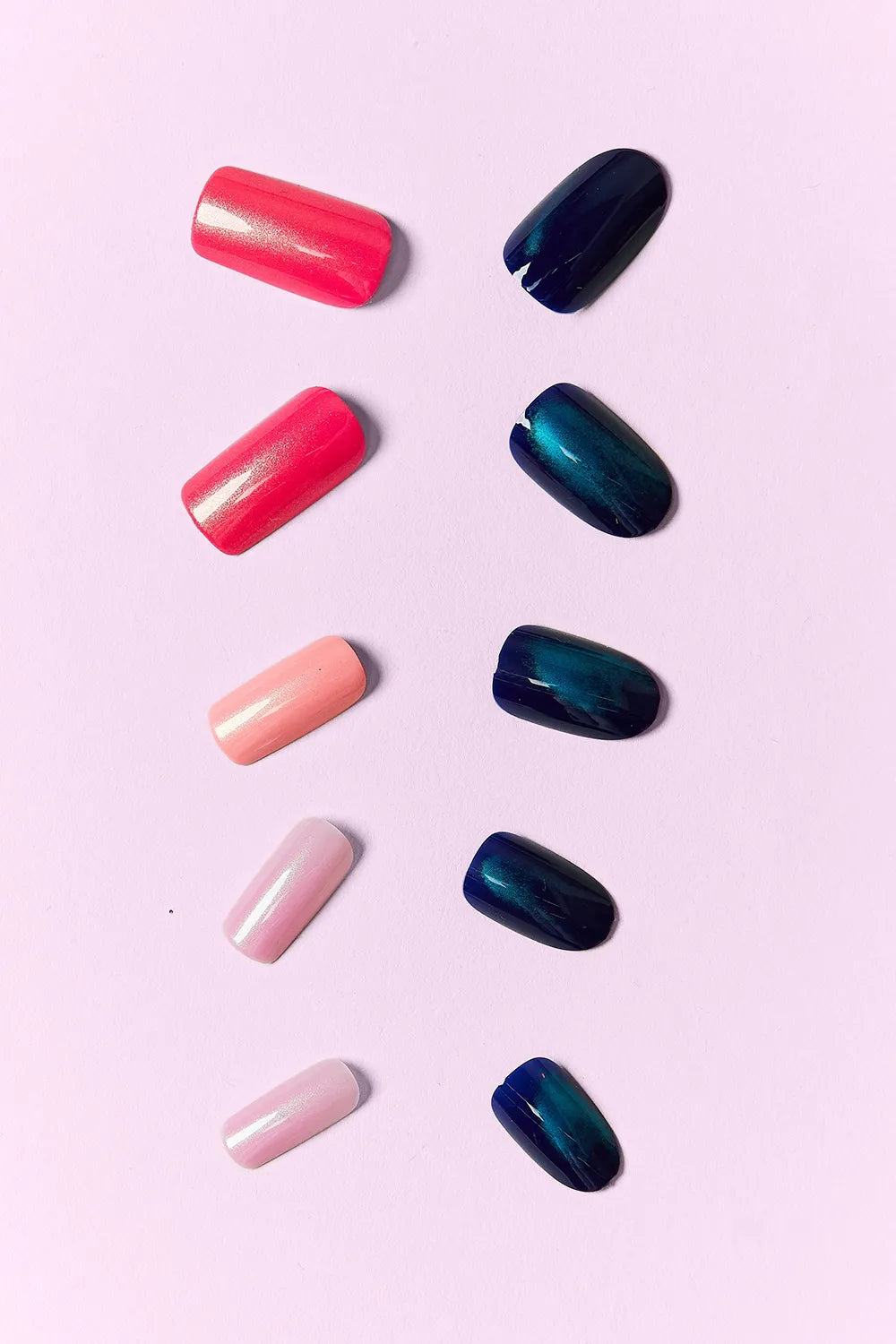Midnight Glam press on nails: glossy coral red and deep navy/blue gradient designs