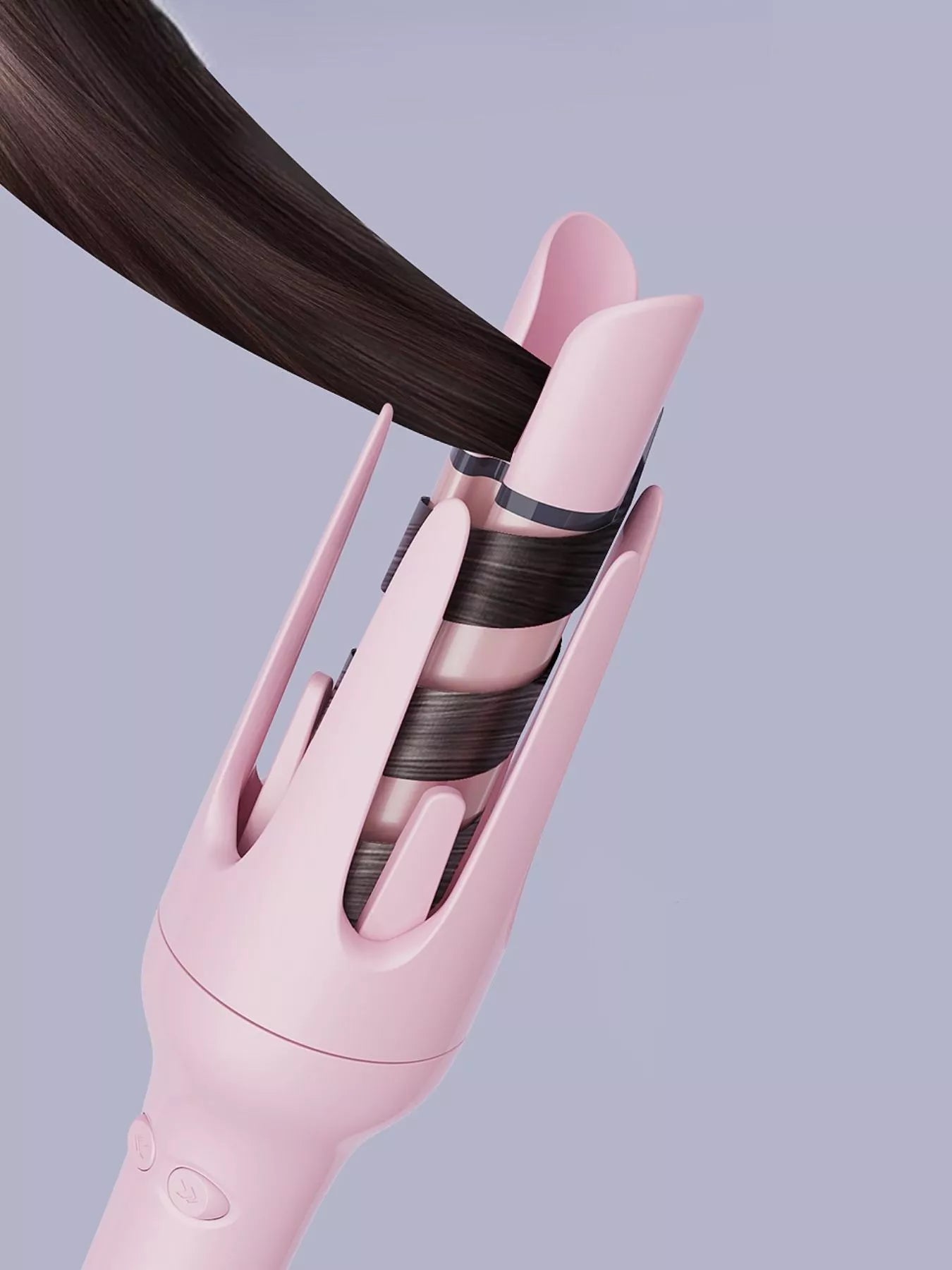 Dusty Pink automatic rotating ceramic hair curler styling a strand of dark hair