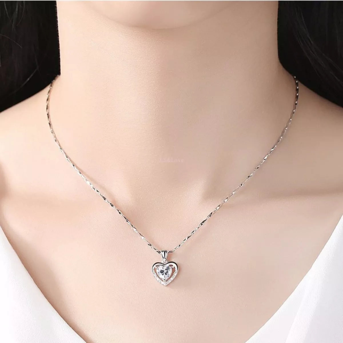 Silver heart zircon necklace with clear center stone and small pavé outline