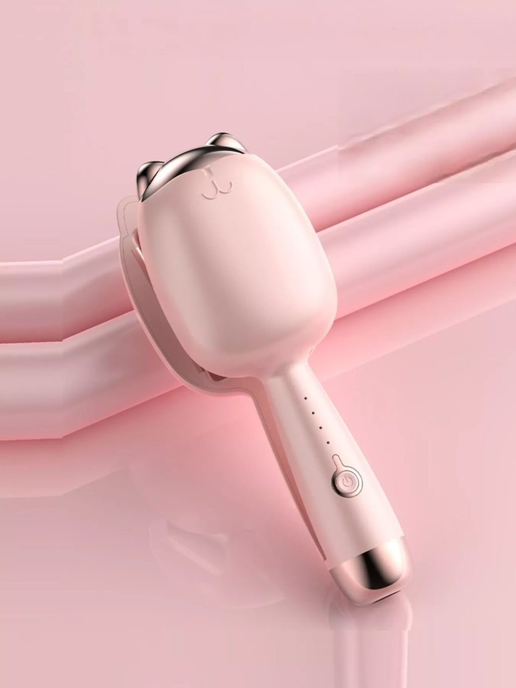 Pale Blush cat-shaped heated curling iron, angled view with power button.