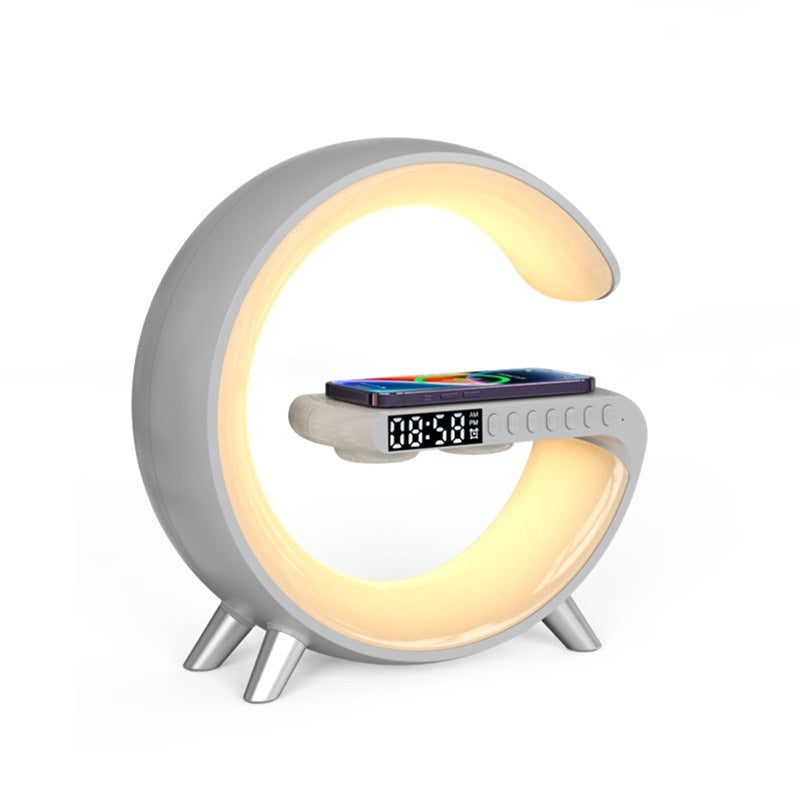 G-shaped LED lamp with Bluetooth speaker and digital clock, light grey base with warm halo light