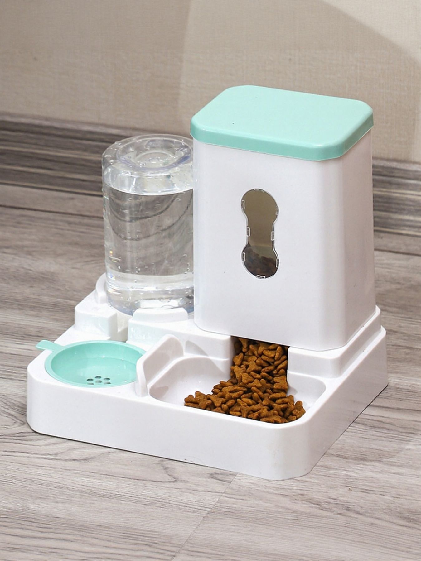 Automatic pet food and water dispenser with mint lid, food tray and water tank.