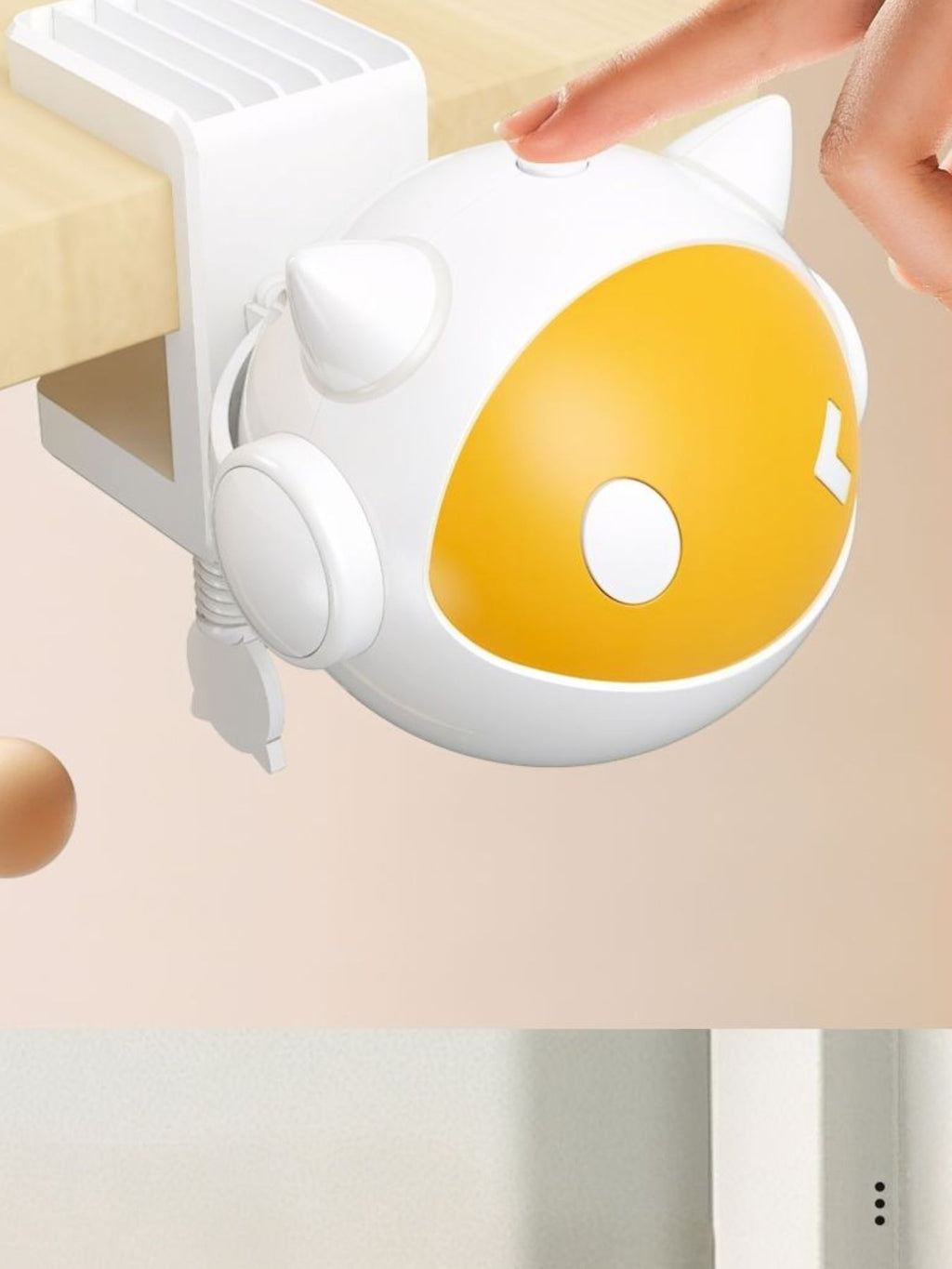White-and-gold egg-style cat teaser toy with ear details and paw-shaped side buttons