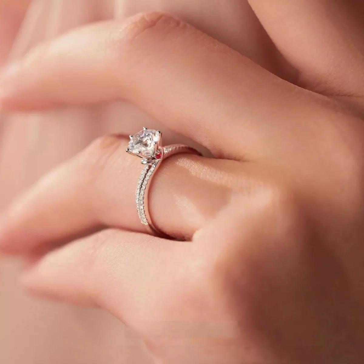 925 sterling silver moissanite ring on hand with textured band and raised center stone
