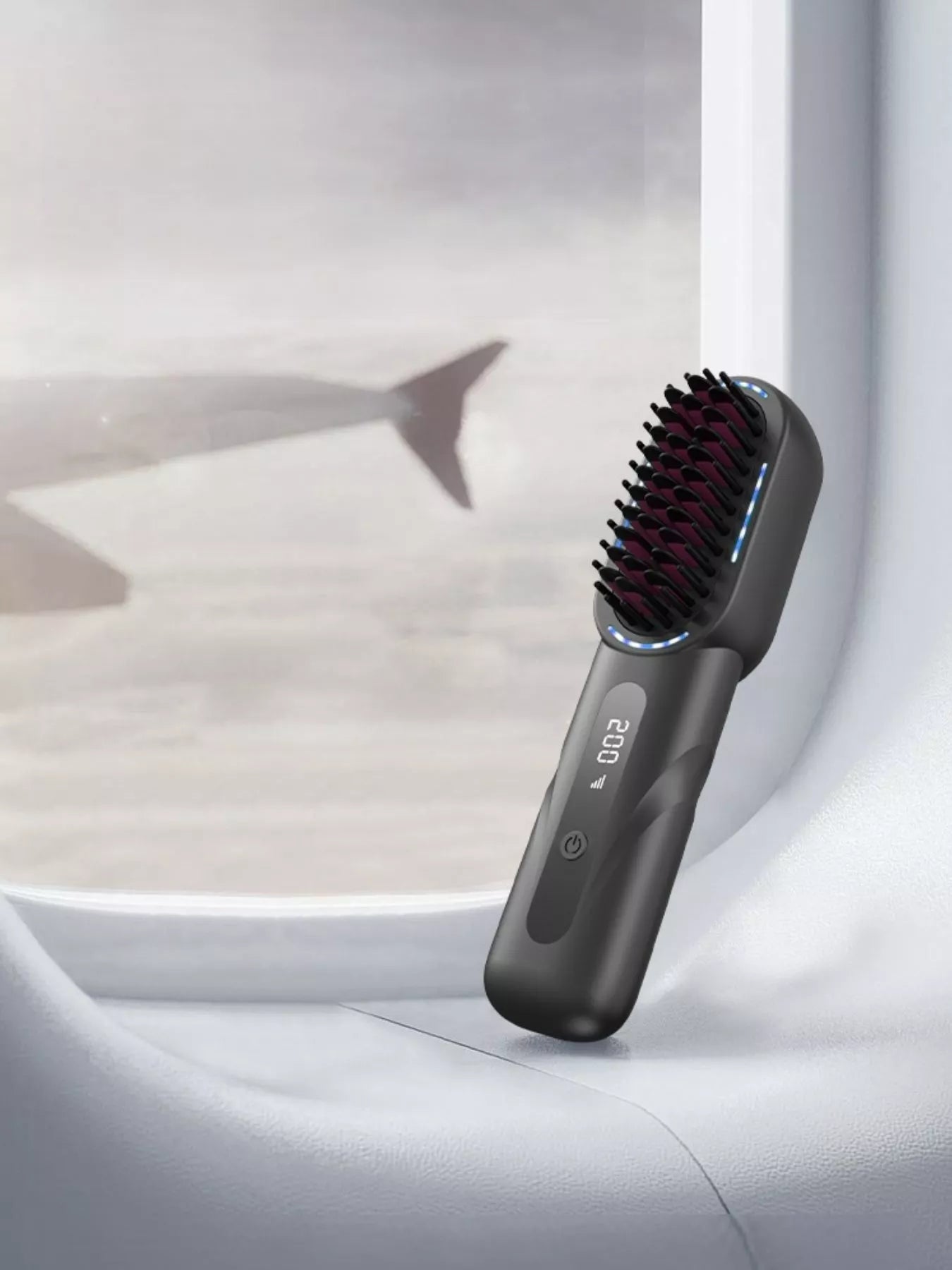 Dark gray heated straightening comb with black bristles and blue indicator lights