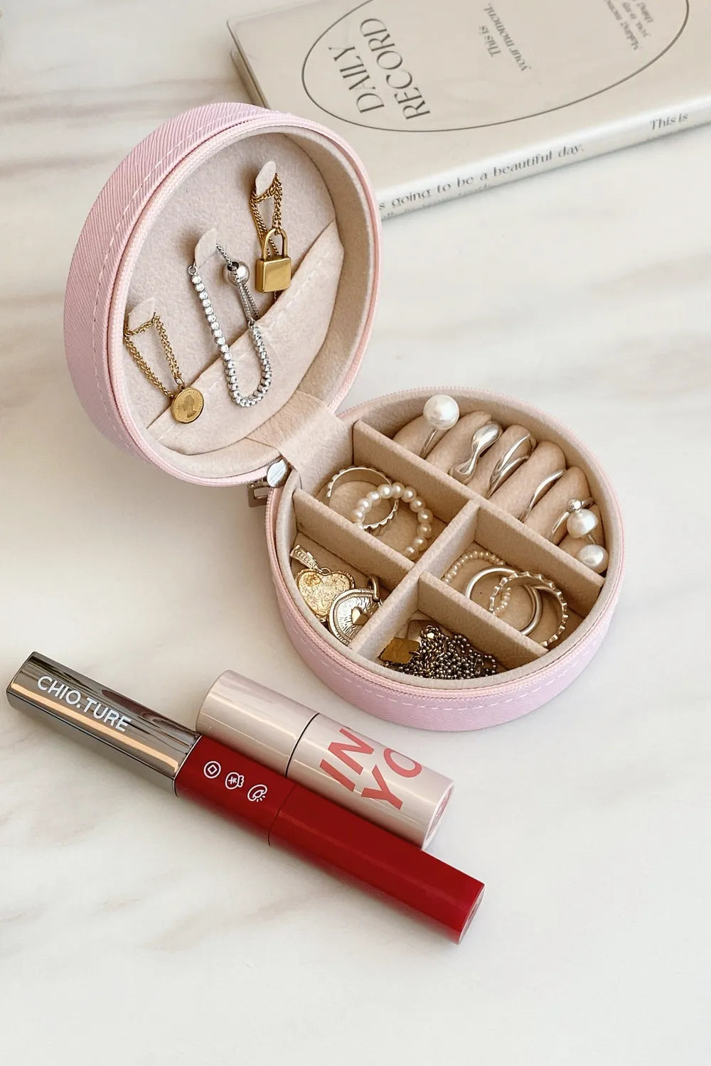 Blush pink PU leather jewelry storage box, open with necklace hooks and ring compartments