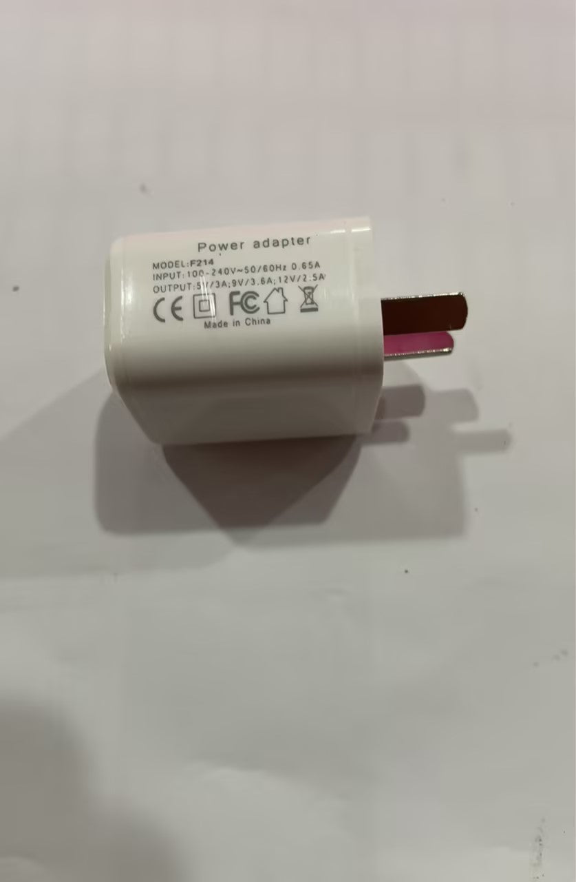 White power adapter with two-pin plug, power label visible on adapter body.
