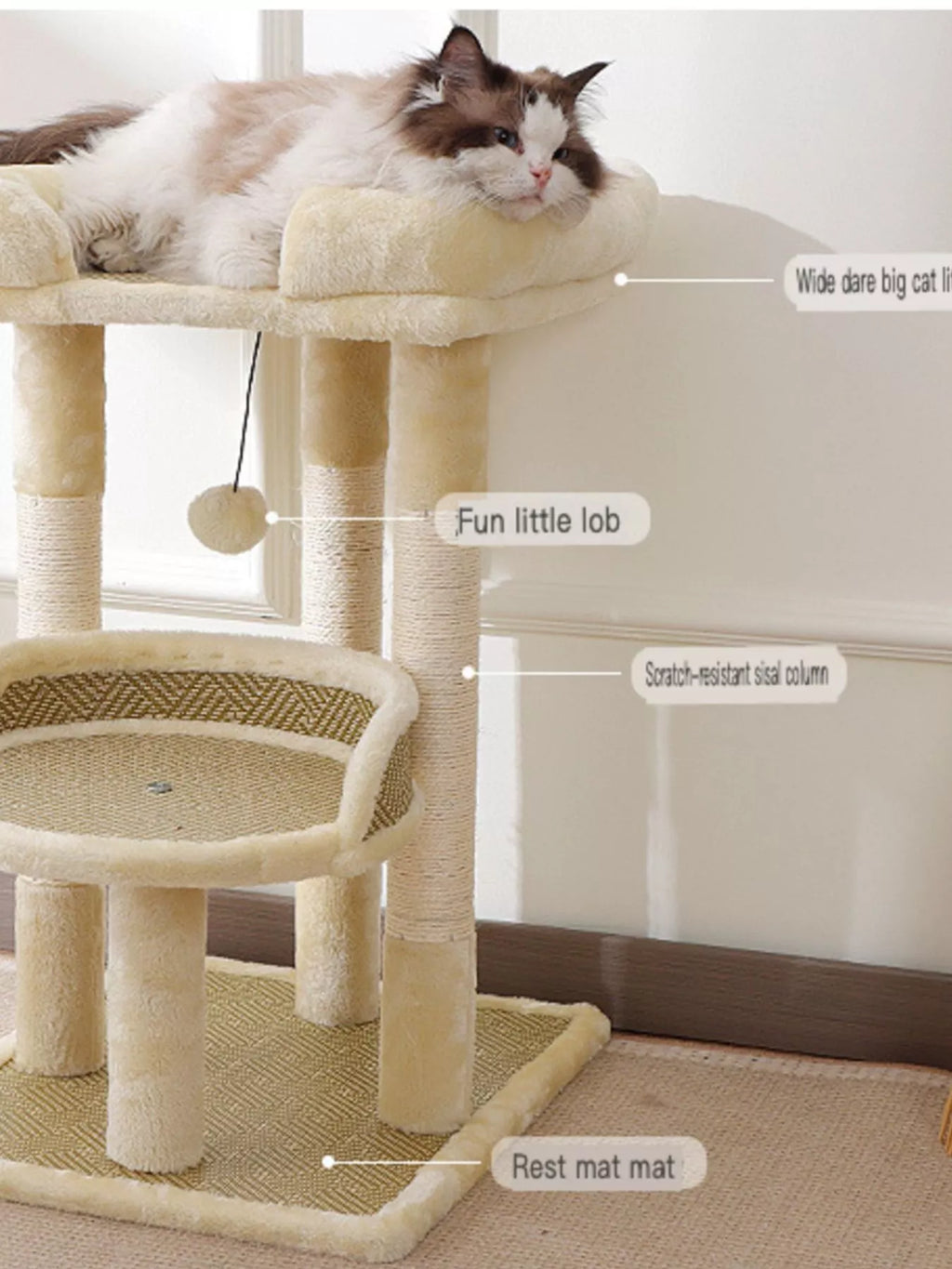 Plush cat tree condo detail: cream perch, hanging ball, and circular sisal scratching pad