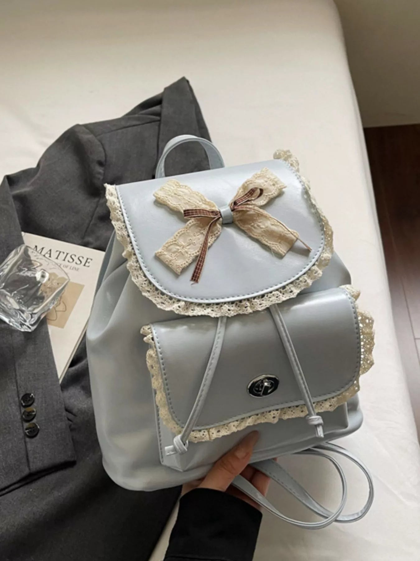 Light blue lace-trim mini backpack with bowknot front flap and crossbody strap