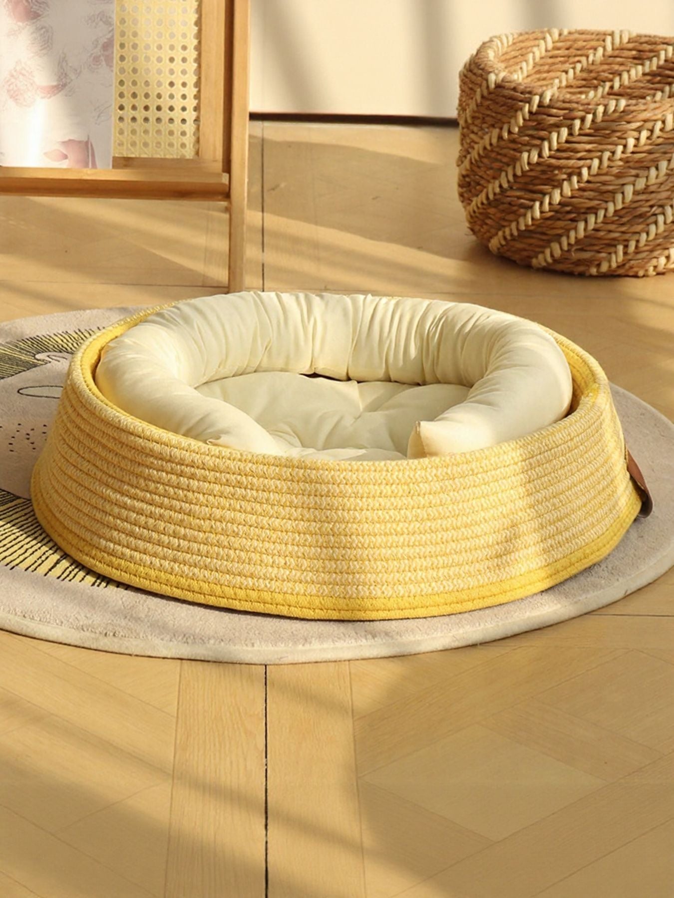 Woven rattan pet nest with yellow woven base and thick beige inner cushion, open
