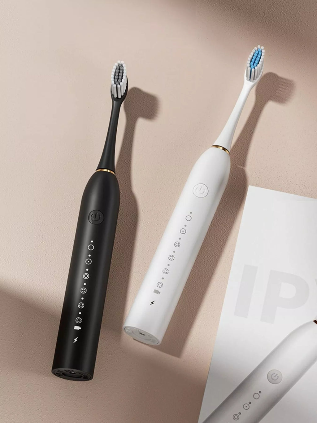 Electric toothbrushes: black and white handles with multi-mode control icons