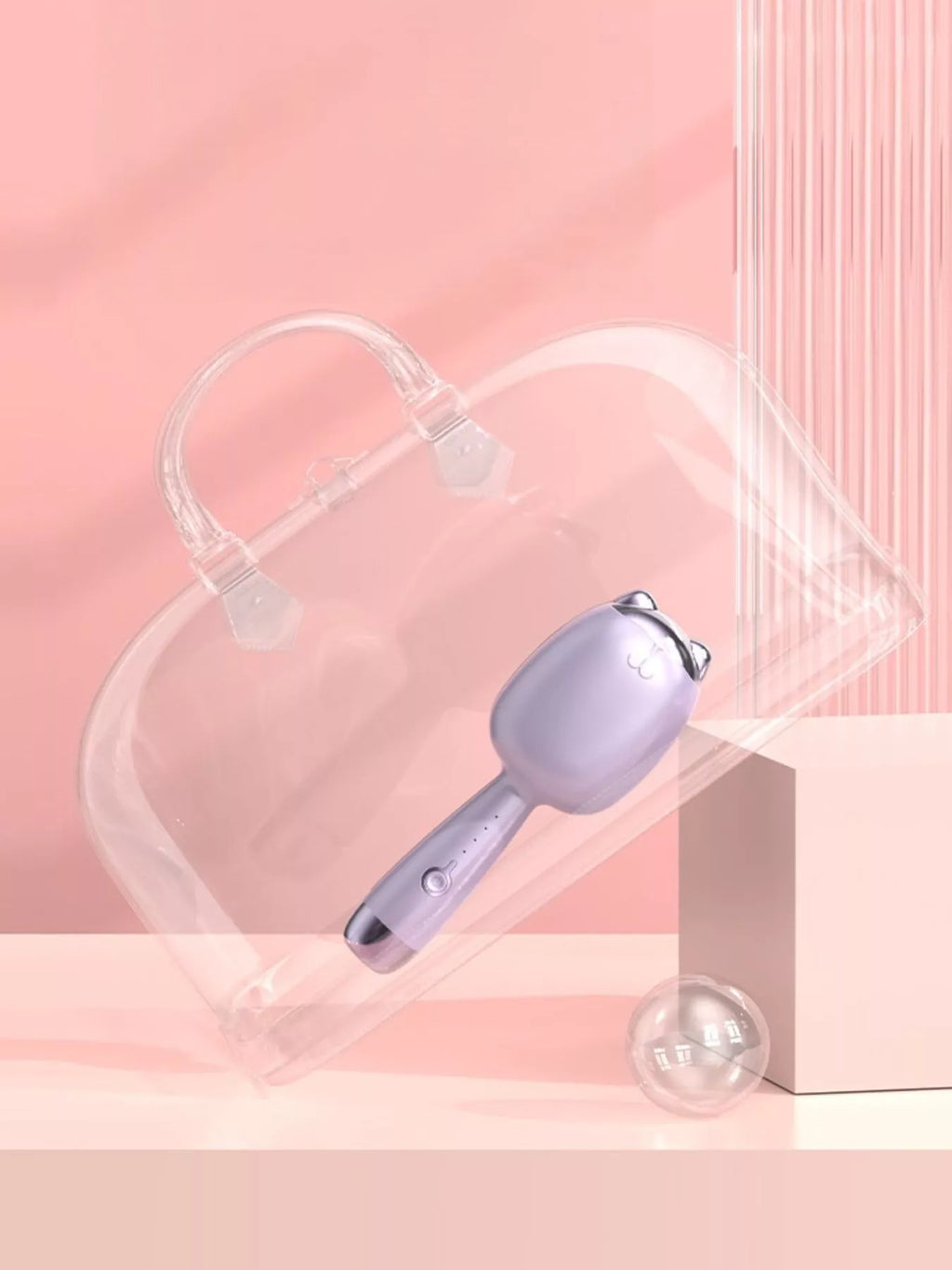 Lilac cat-shaped heated curling iron with clear guard and exposed curling area.