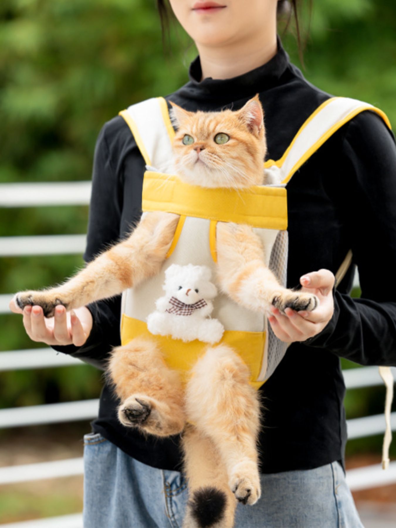 Yellow breathable pet carrier front pack with stuffed toy detail, cat inside