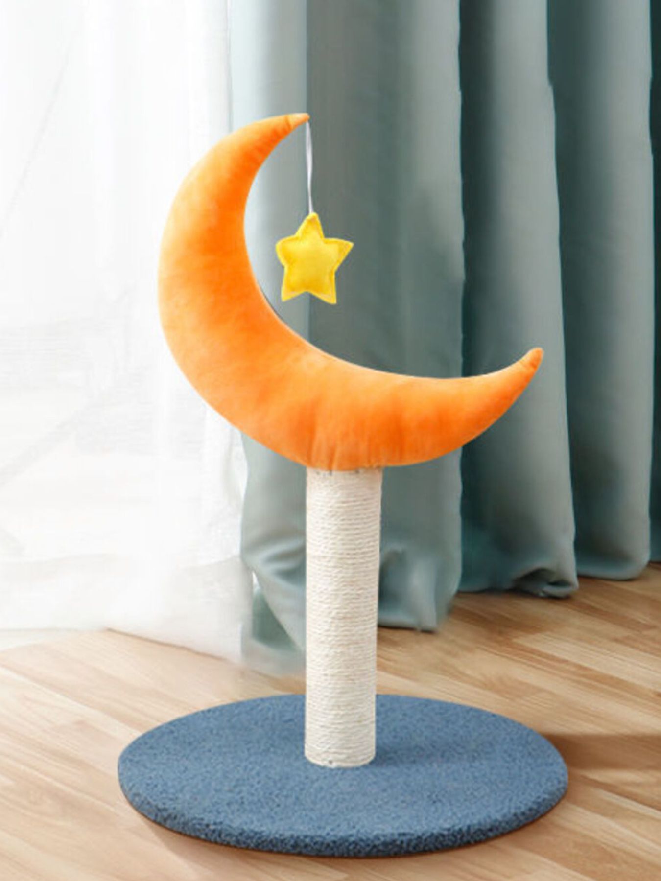Orange moon-shaped cat scratching post with yellow star toy on beige post and blue base