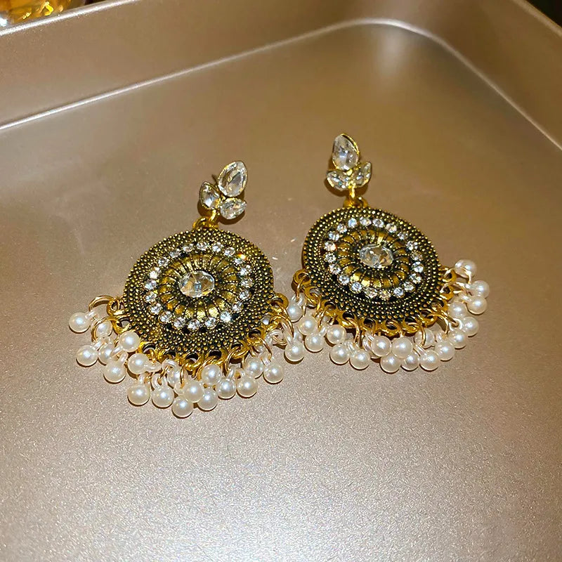 White rhinestone alloy dangle earrings with round center and pearl drop fringe