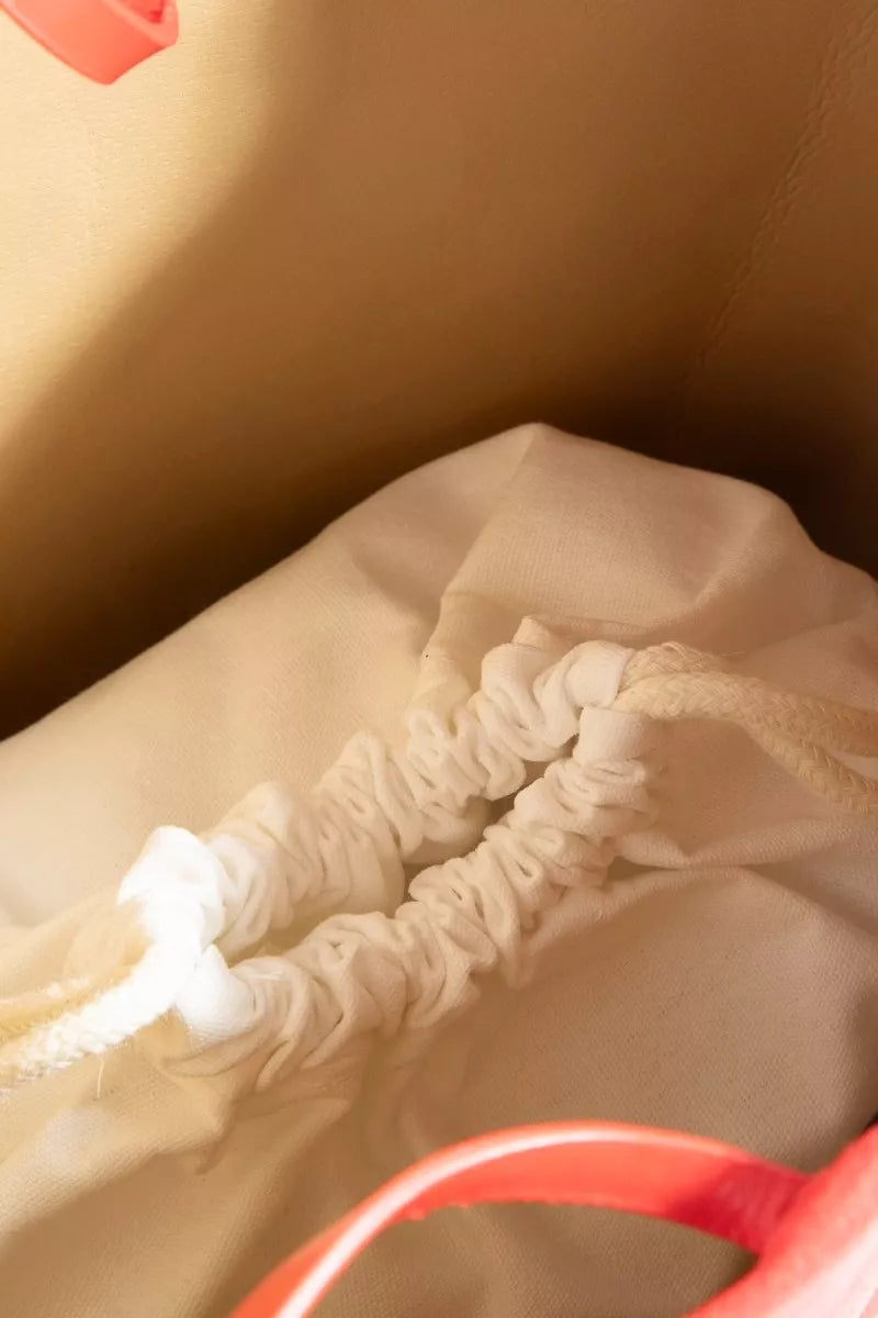 Drawstring pouch detail for faux suede tote, white gathered cord closure