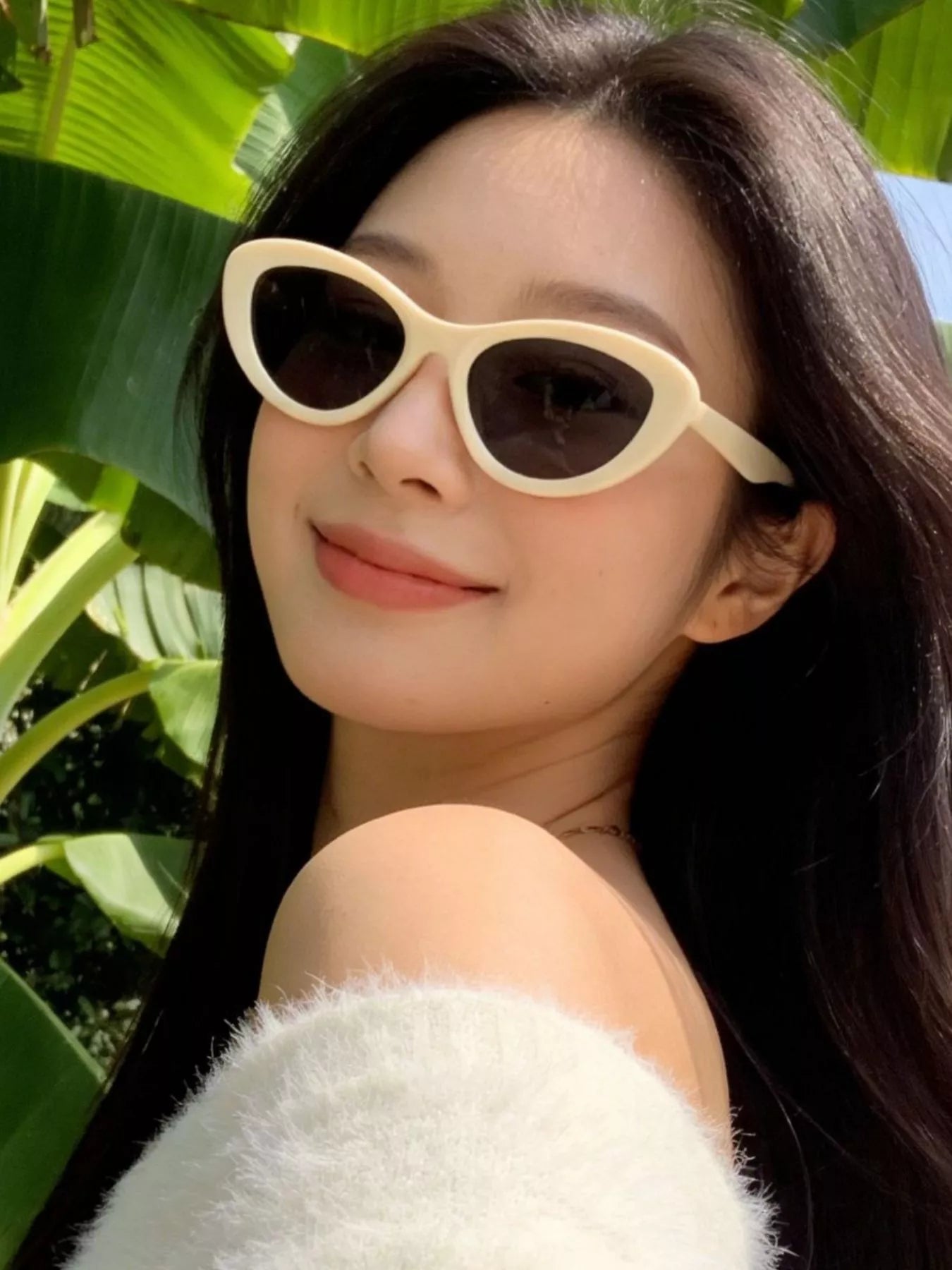 Cat-eye sunglasses, ivory frames with dark lenses