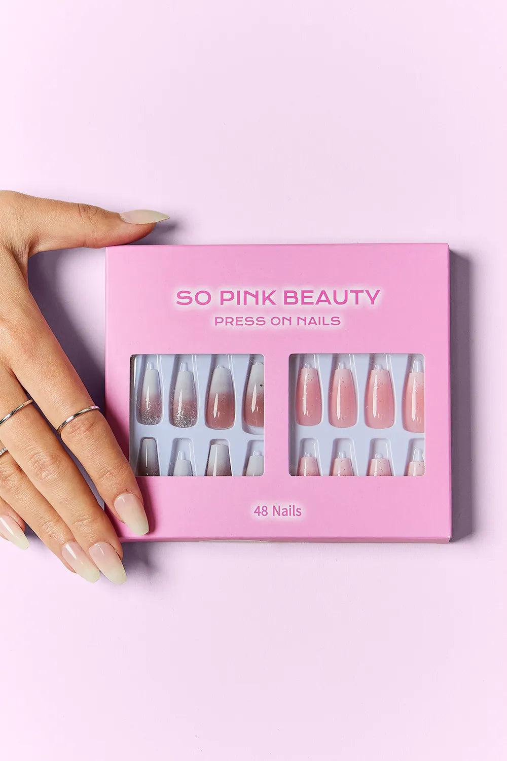 SO PINK BEAUTY Press on Nails 2 Packs box with 48 nails, shown by hand