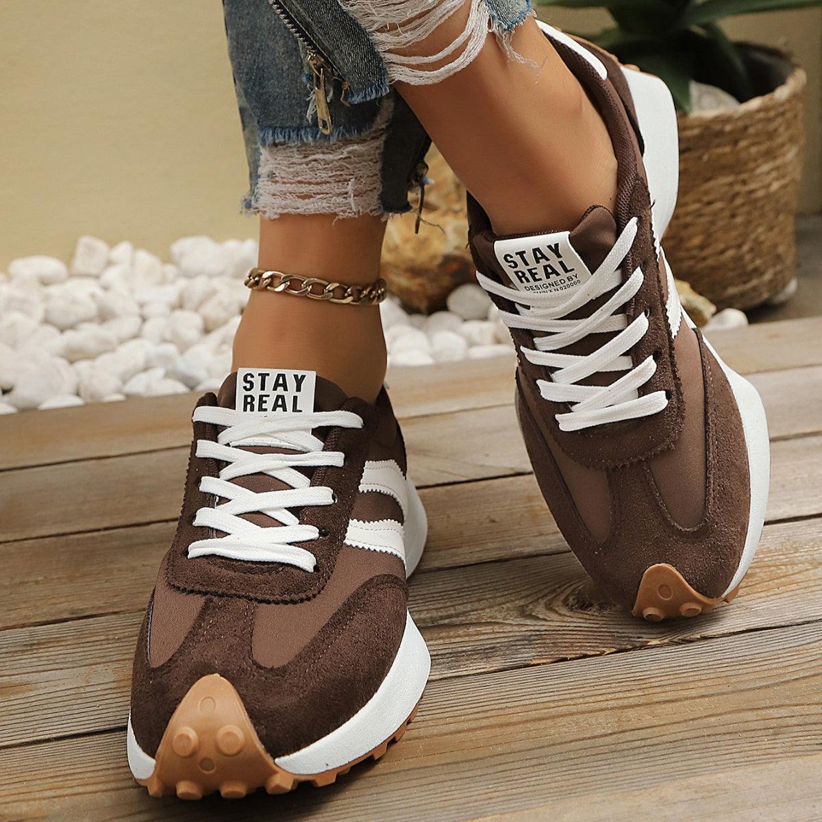 Brown round-toe lace-up sneakers with white stripes and thick rubber sole