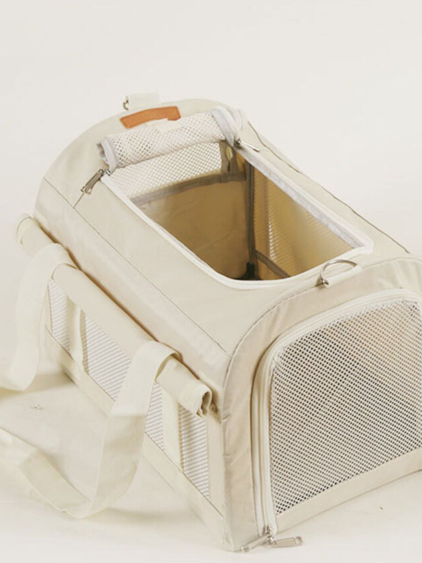 Pet carrier bag with mesh side panels and interior liner, open top, white.