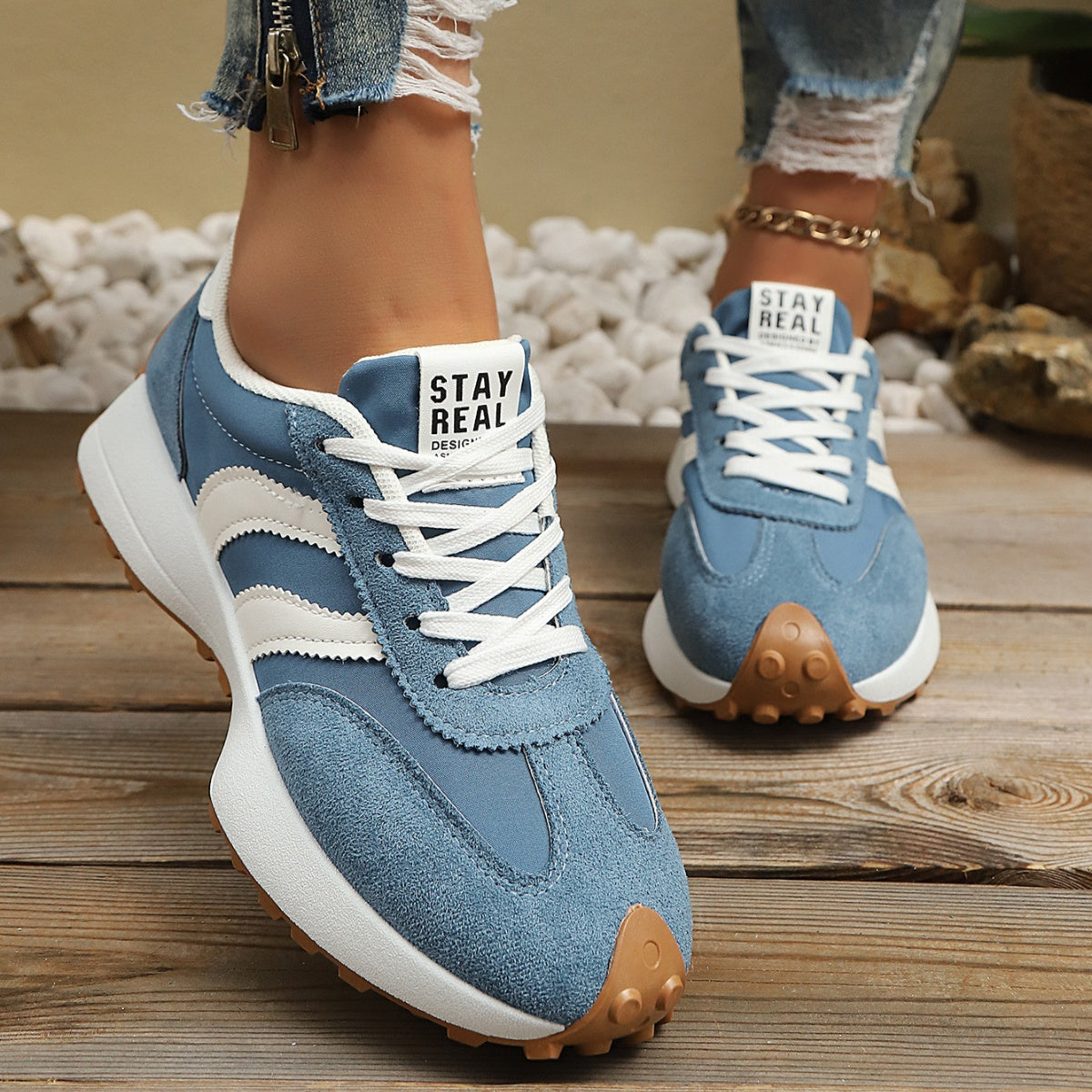 Sky-blue round-toe lace-up sneakers with white stripes and gum sole