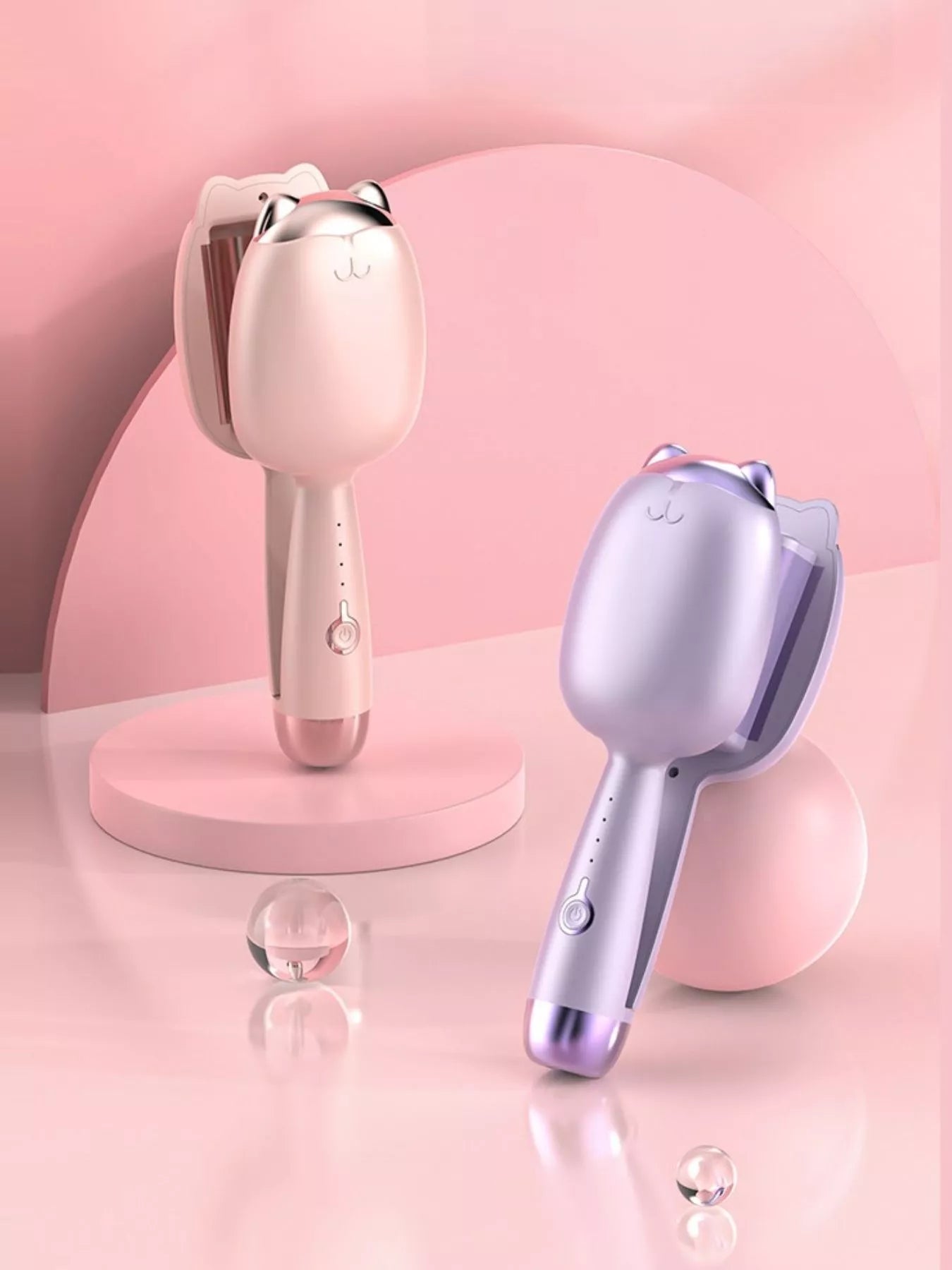 Set of cat-shaped heated curling irons in Pale Blush and Lilac, standing side by side.