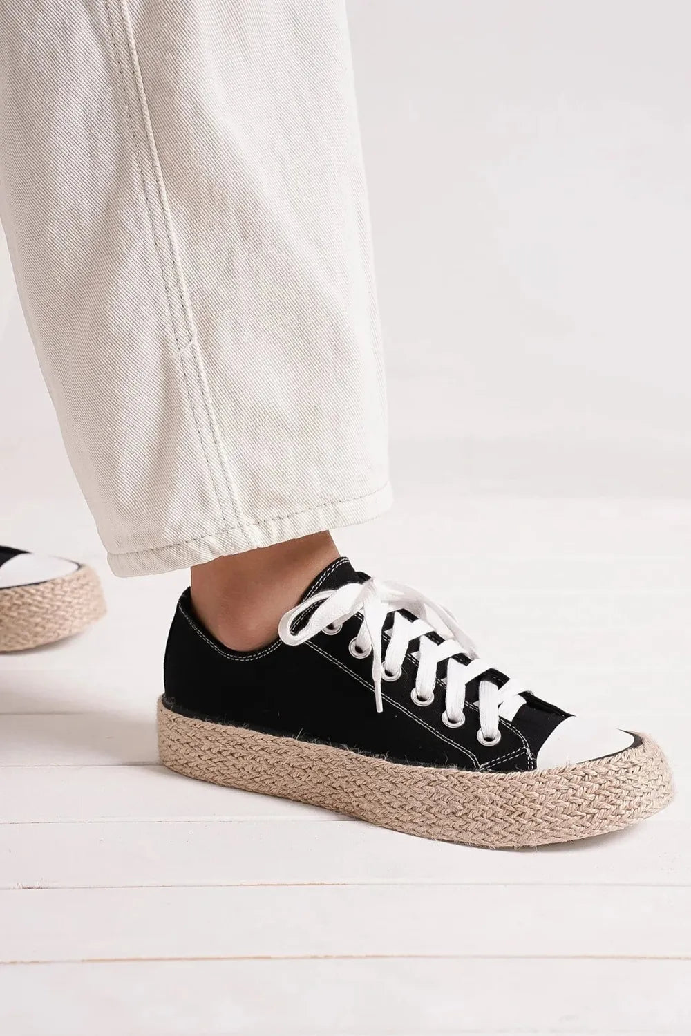 Black espadrille sole sneakers with white laces and white toe cap