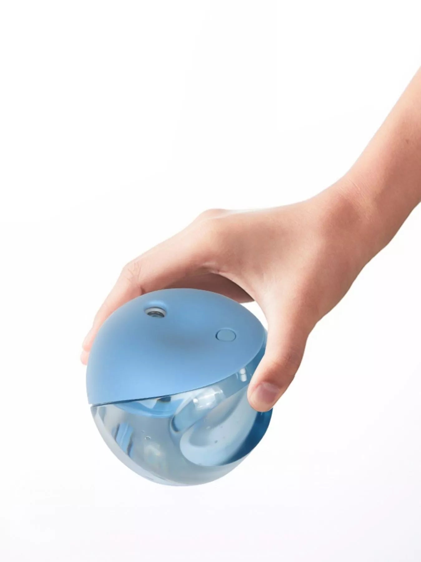 Light blue apple-shaped humidifier held in a hand