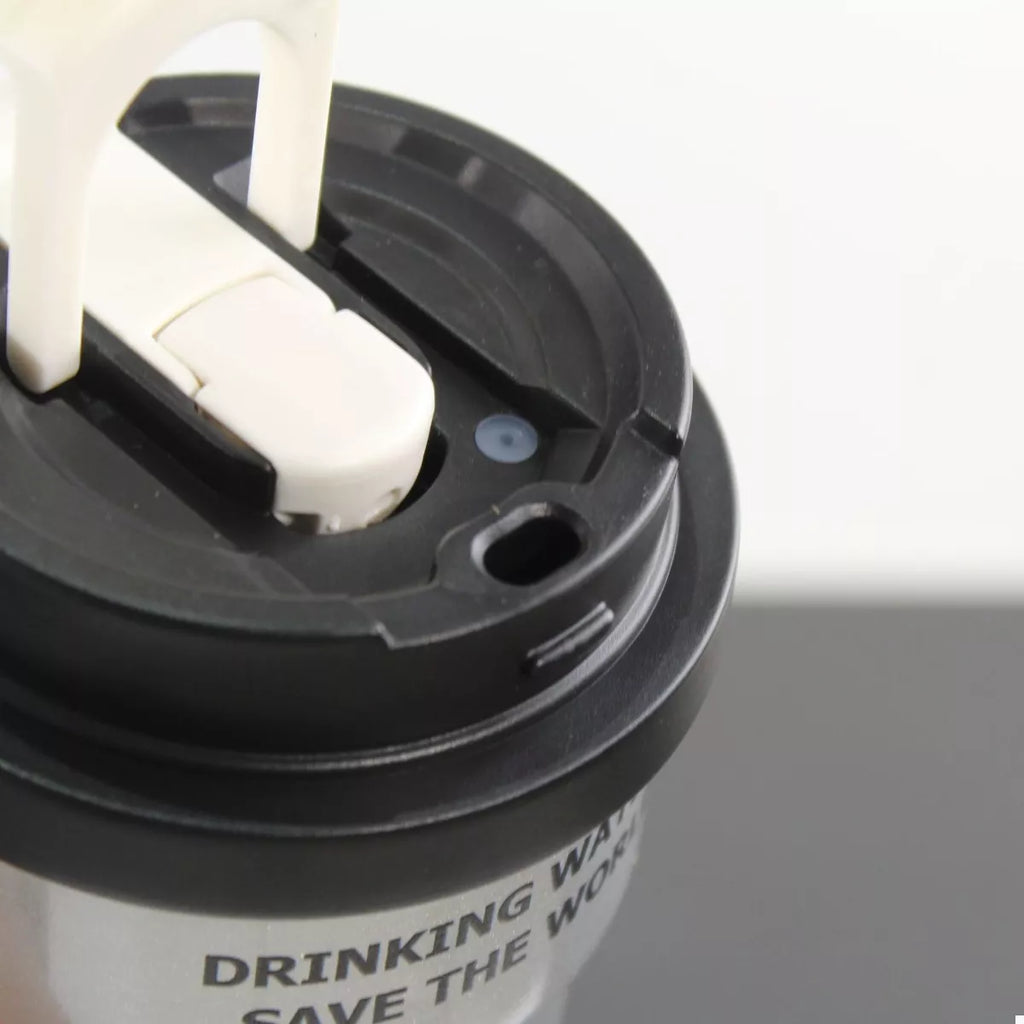 Black tumbler lid with straw inserted, drinking opening and latch detail