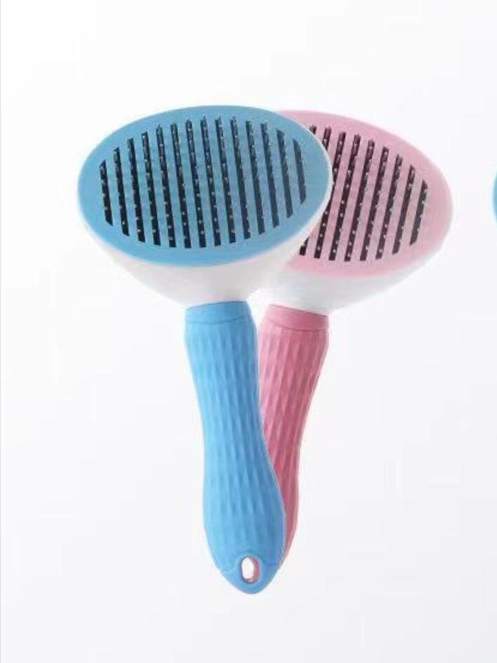 Blue and pink plastic pet hair remover combs, oval heads and textured handles