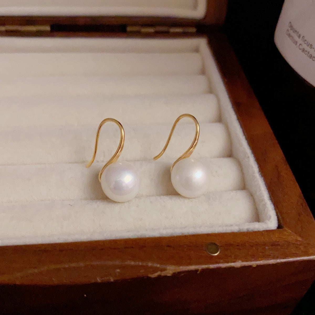 Gold-tone pearl drop earrings, round white pearls on curved hook backs