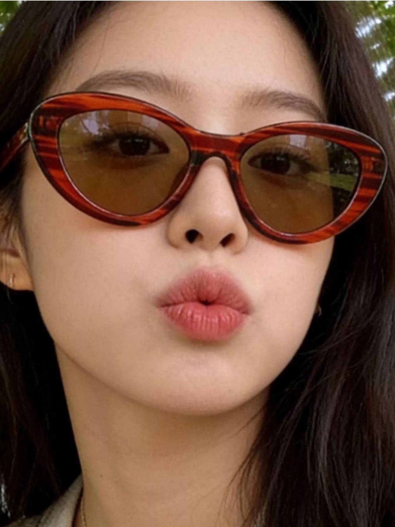 Cat-eye sunglasses, orange tortoiseshell frames, tinted lenses
