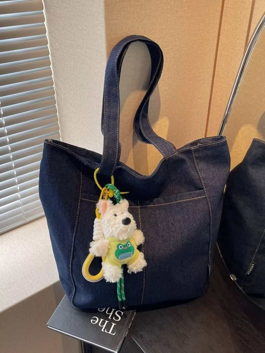 Denim shoulder bag in dark navy with cute charm and long top handles