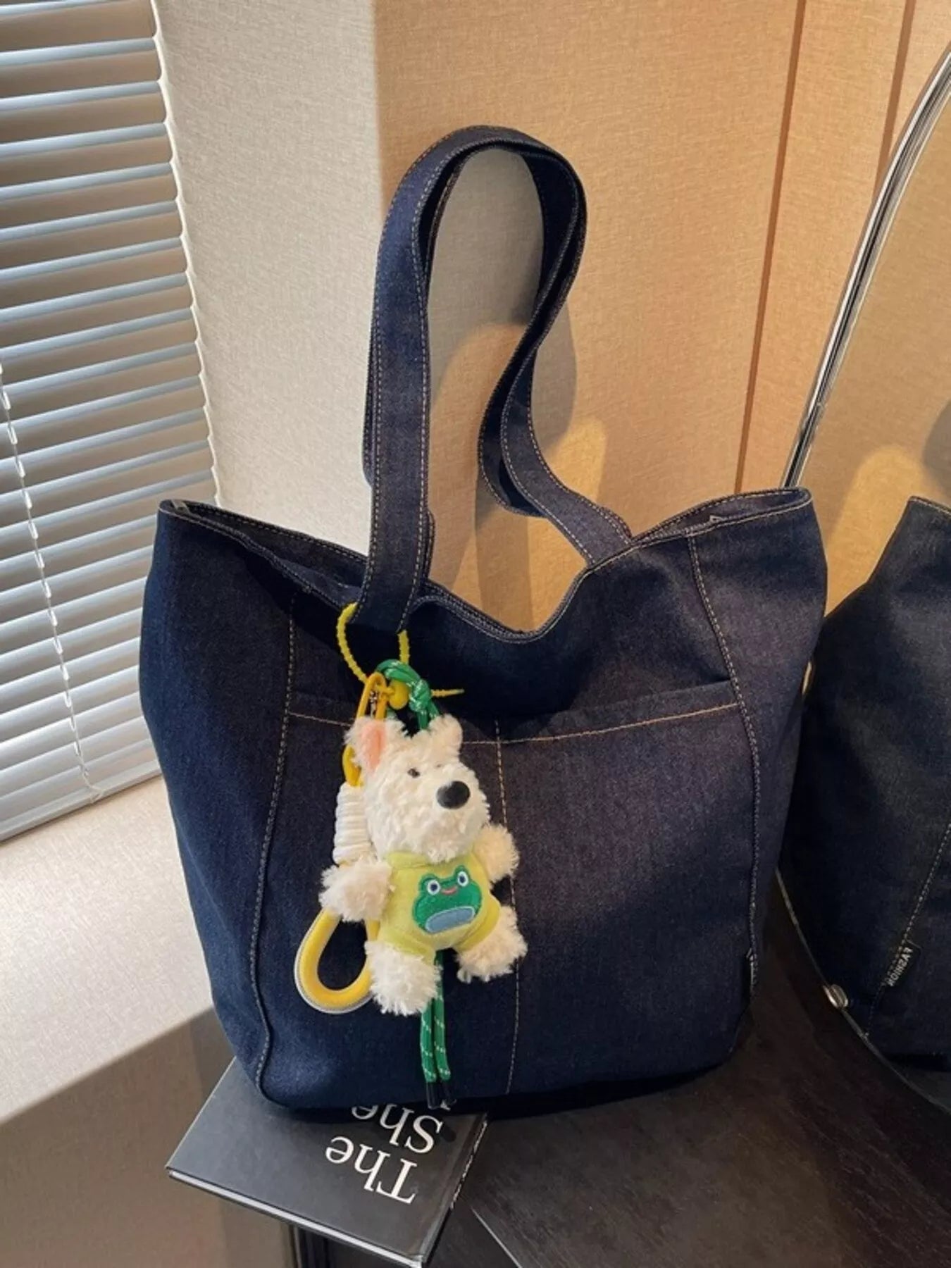 Denim shoulder bag in dark navy with cute charm and long top handles