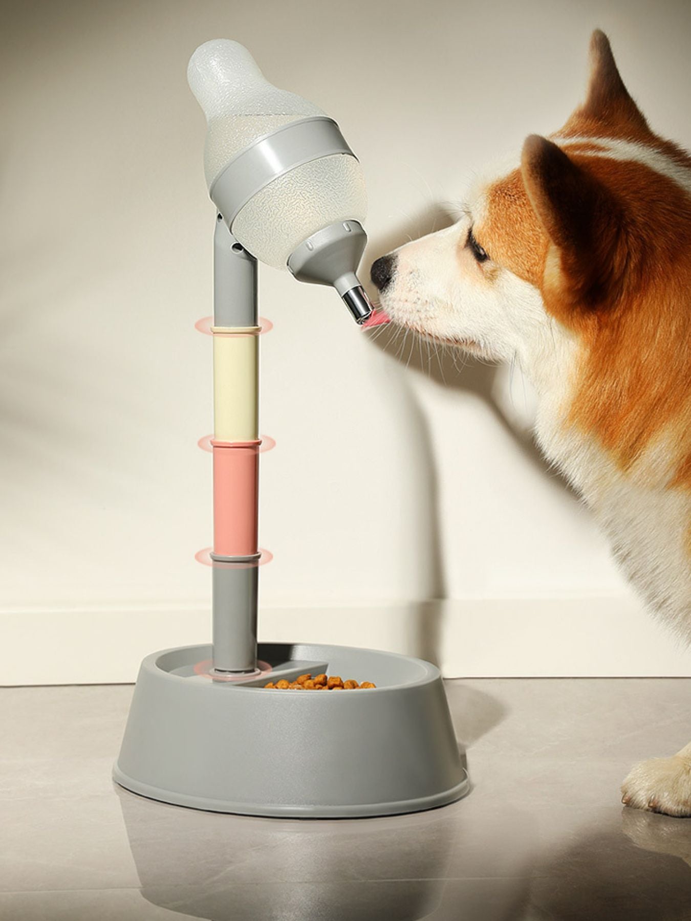 Dog drinking from automatic pet water dispenser bowl, gray base with pink stem
