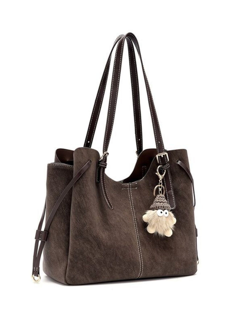 Brown shoulder bag with adjustable straps and hanging pom charm at the front