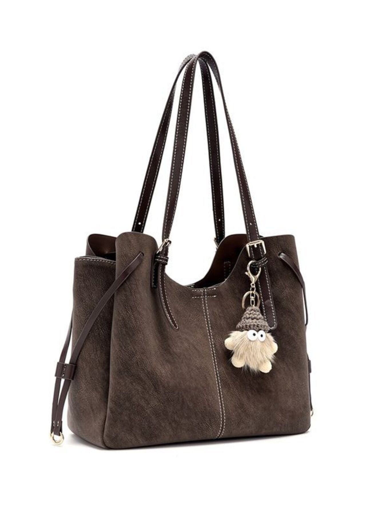 Brown shoulder bag with adjustable straps and hanging pom charm at the front