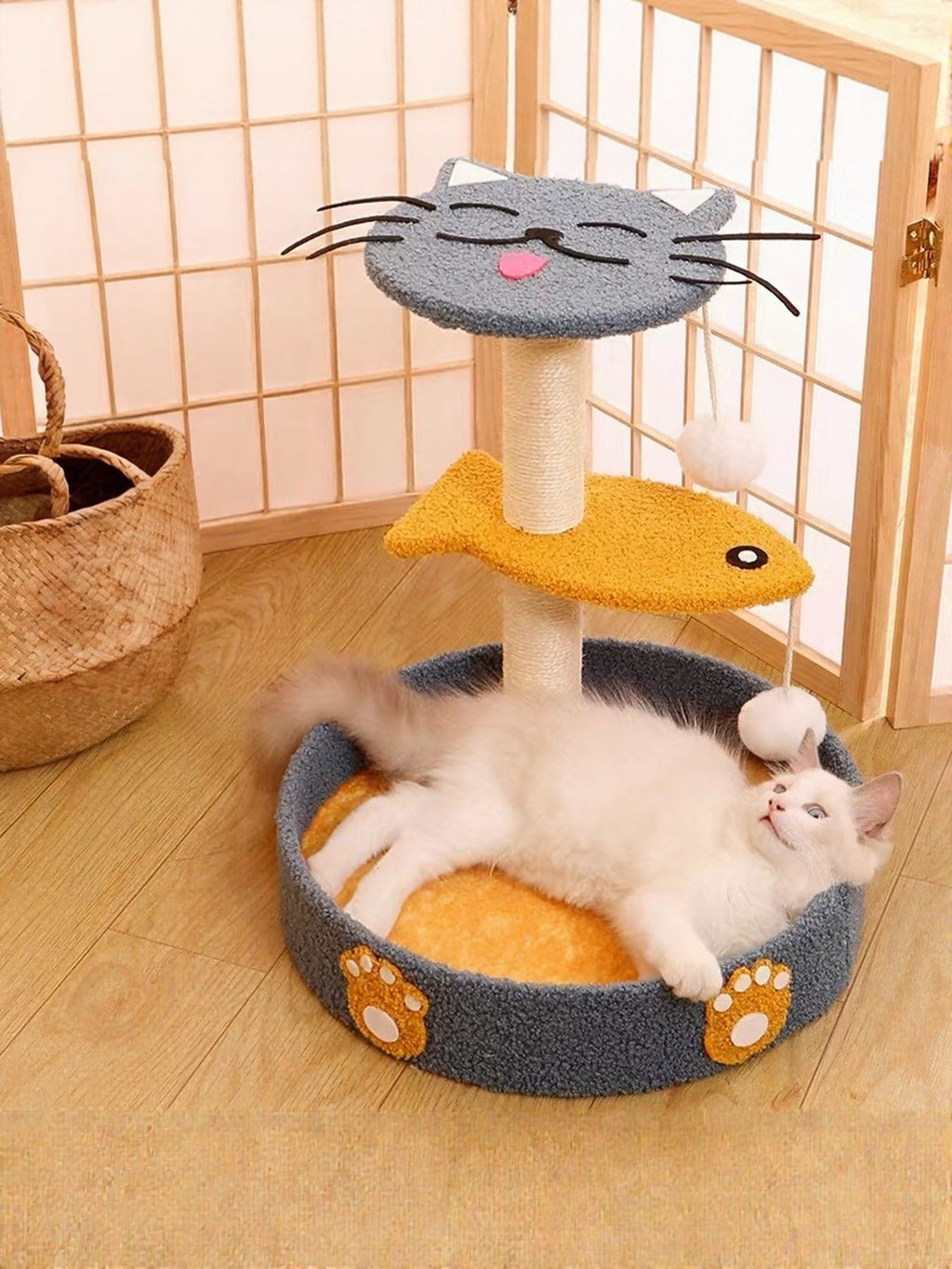 Cat scratching post with circular plush bed, gray with orange base and dangling fish toy