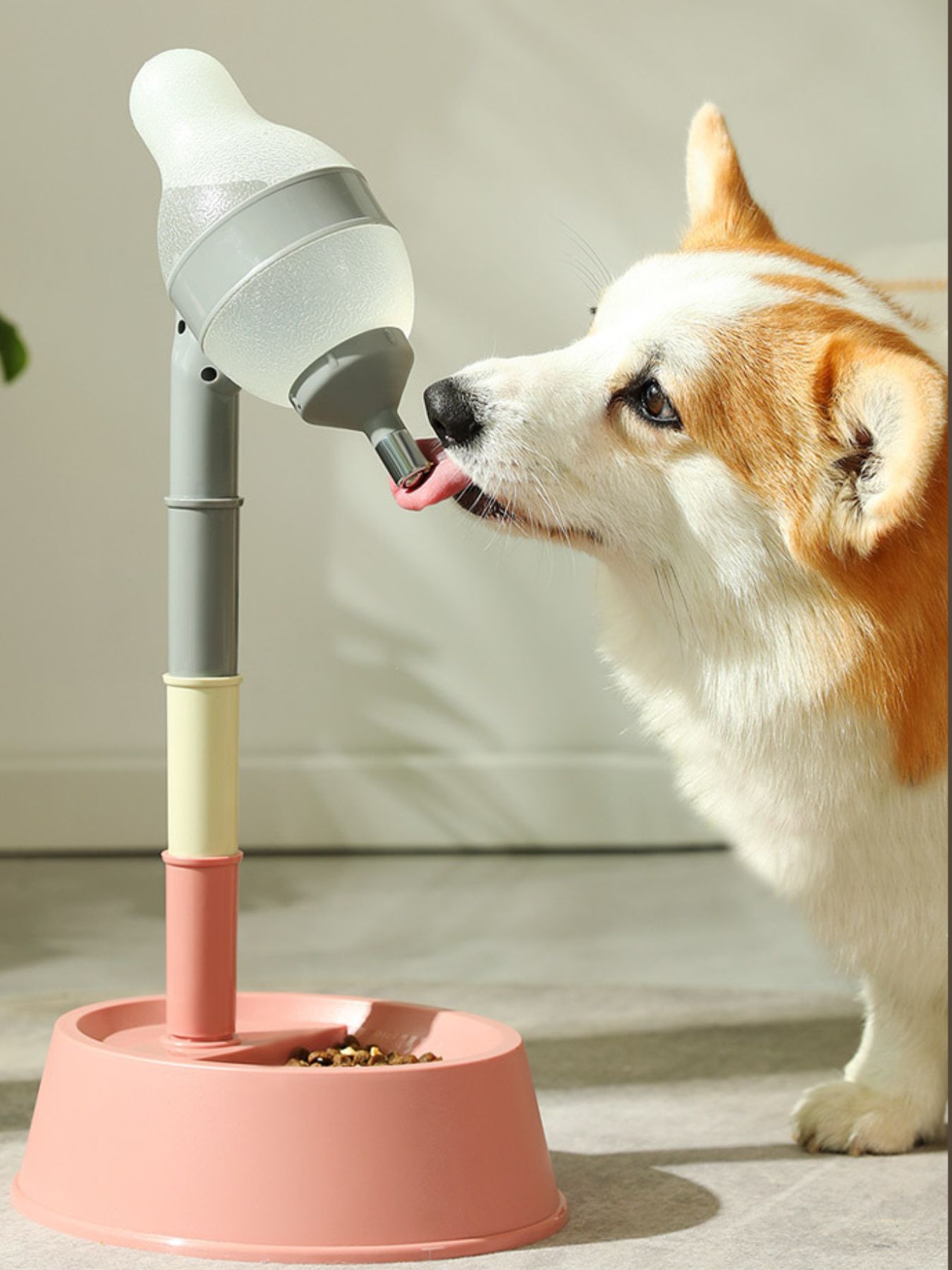 Pink automatic pet water dispenser bowl with adjustable stand, dog drinking from nozzle