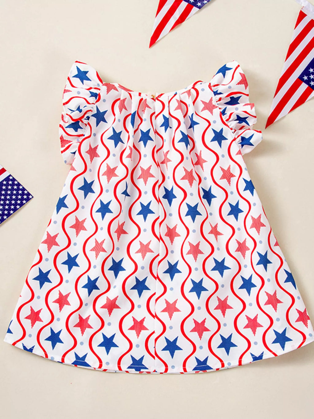Front view: star and flame-pattern patriotic dress with ruffled cap sleeves