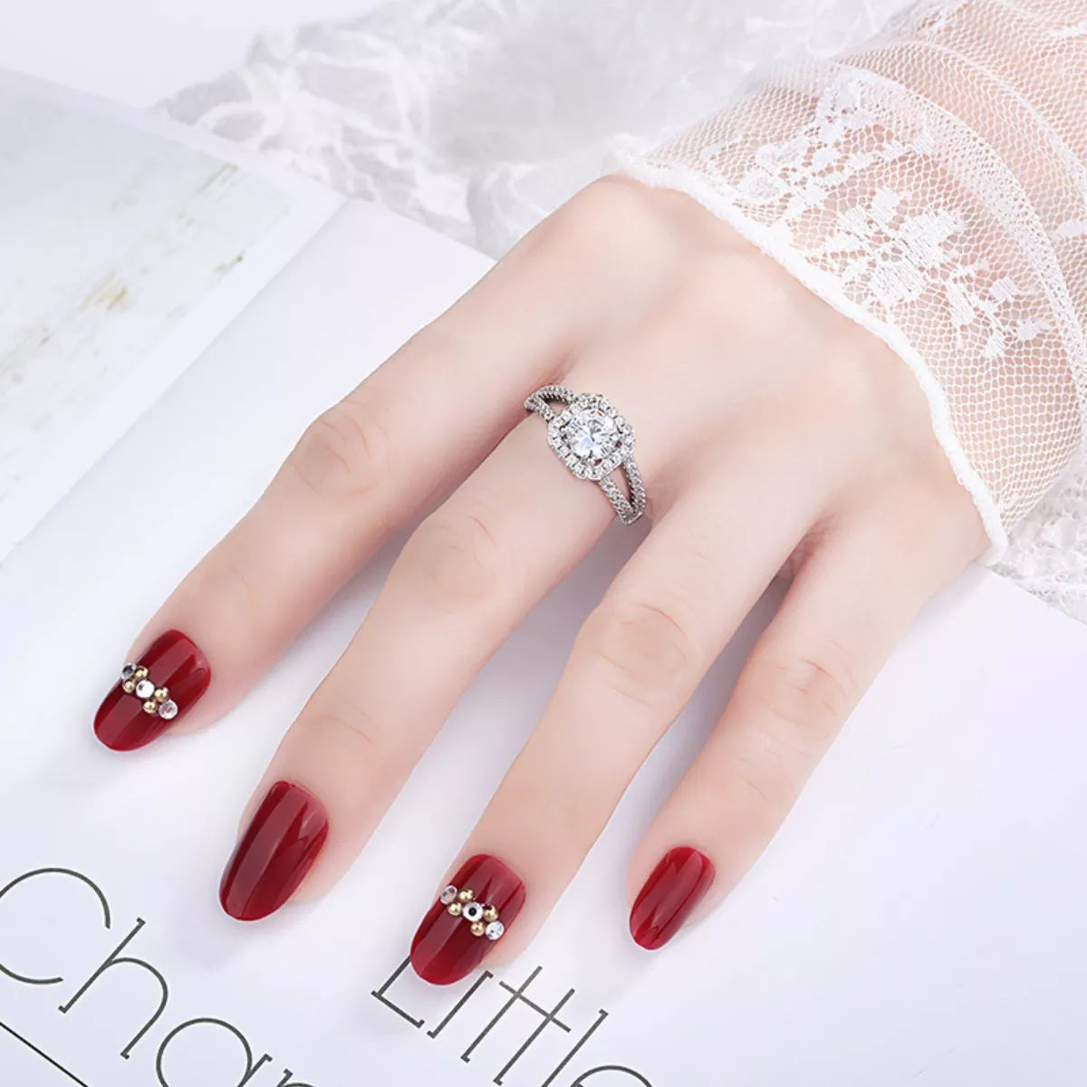 Moissanite halo ring on hand, 925 sterling silver setting with pavé detail