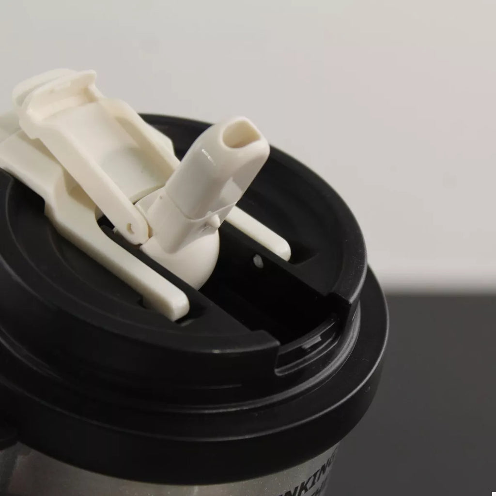 Tumbler lid top with straw opening and hinge latch, black base, white straw