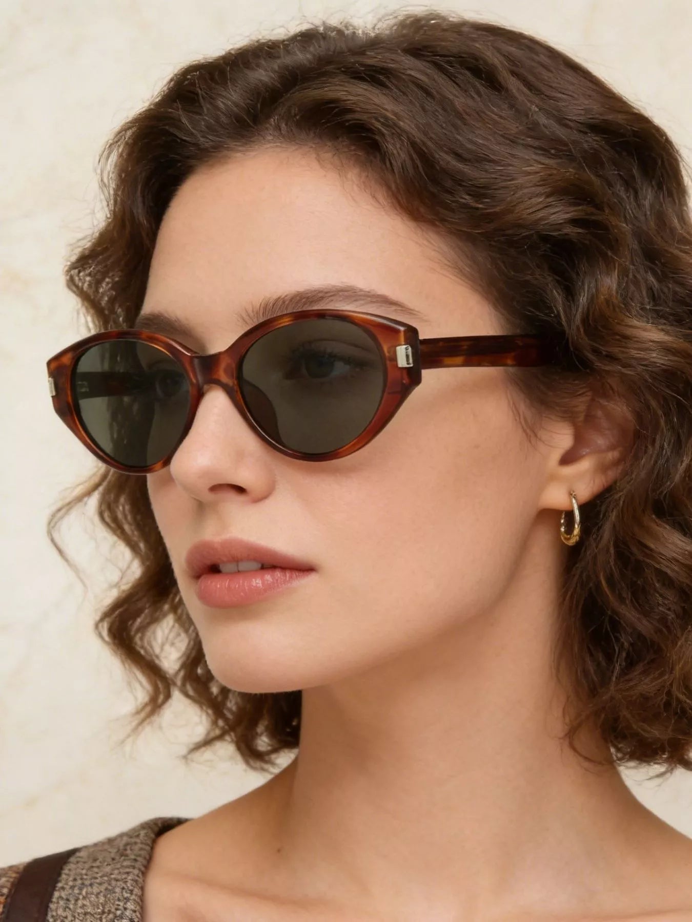 Lightweight cat-eye sunglasses in tortoiseshell with dark lenses and metal logo