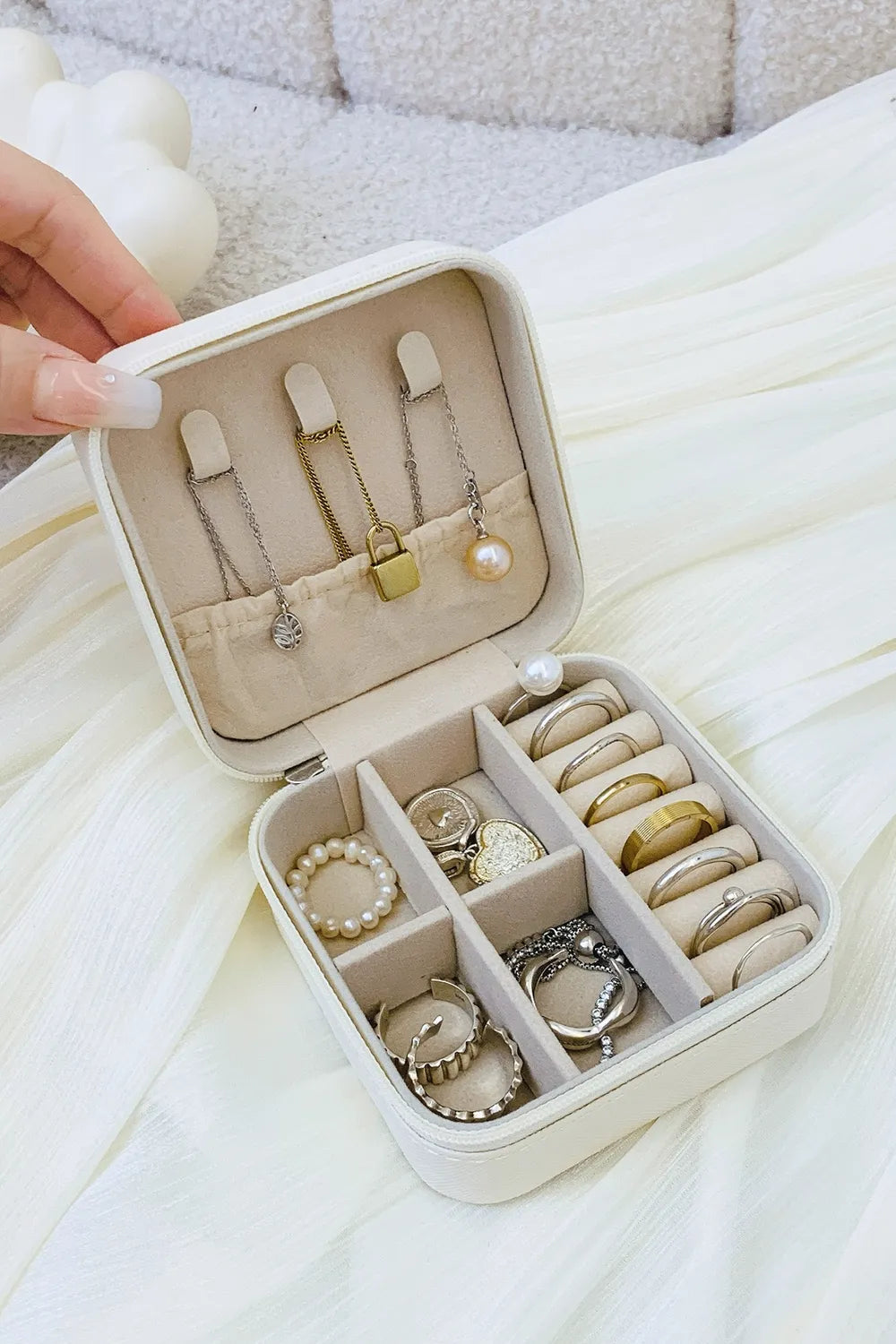 White PU leather square jewelry box, open with earring slots and ring compartments.