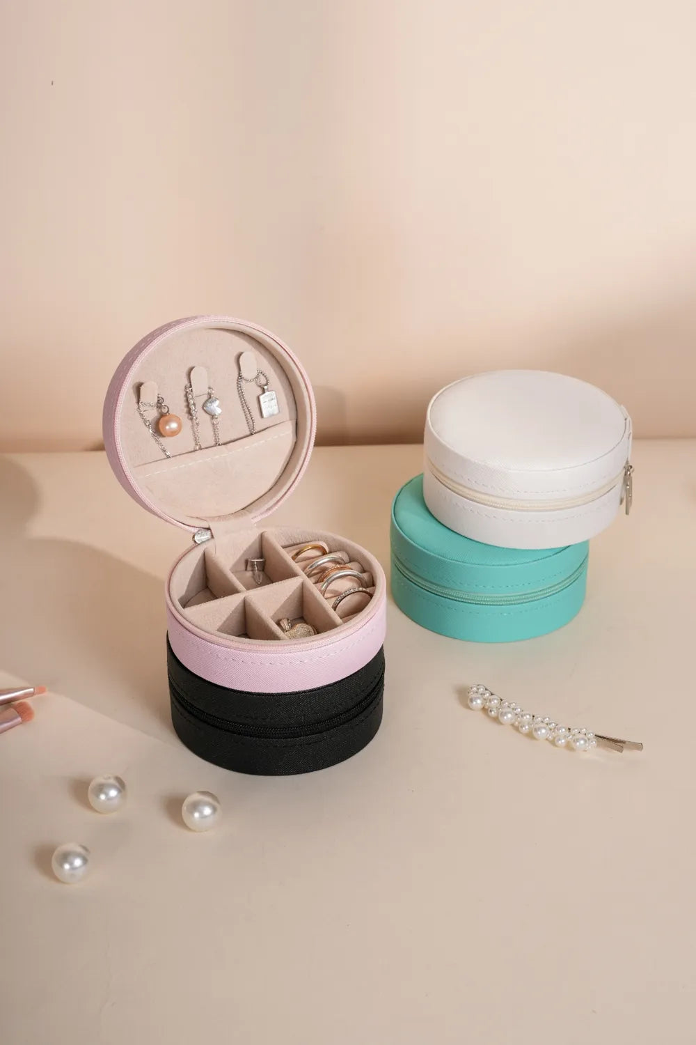 Blush pink PU leather jewelry storage box, round zipper case open with compartments and jewelry