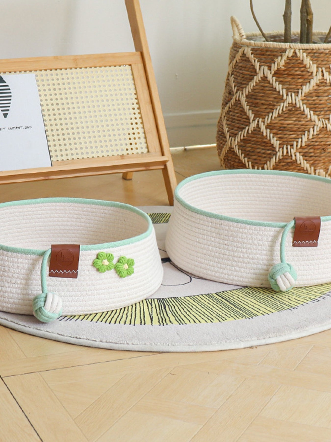 Two woven pet nests in white with mint trim; green clover patch and rope detail