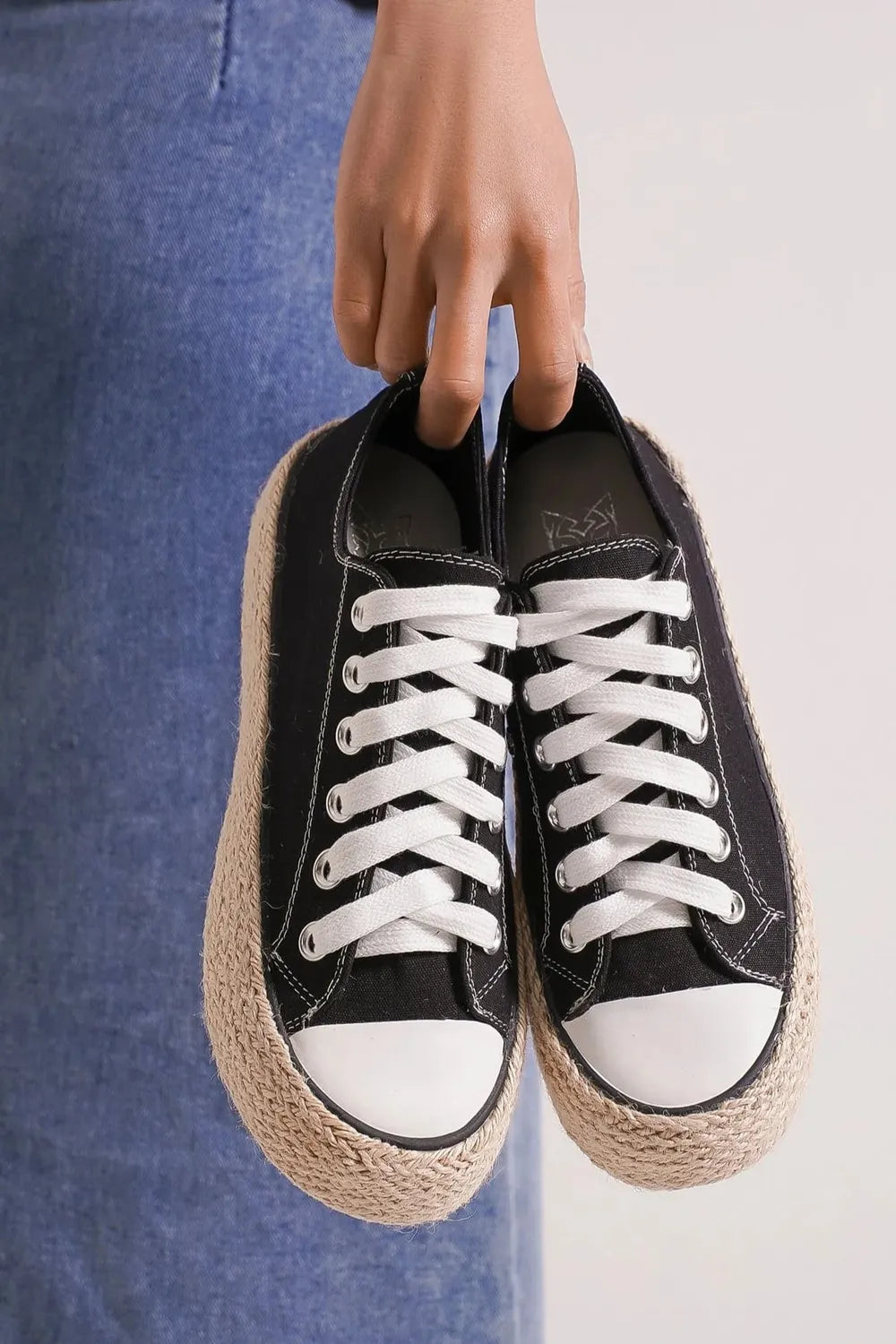 Black lace-up espadrille sole sneakers with white laces and canvas uppers