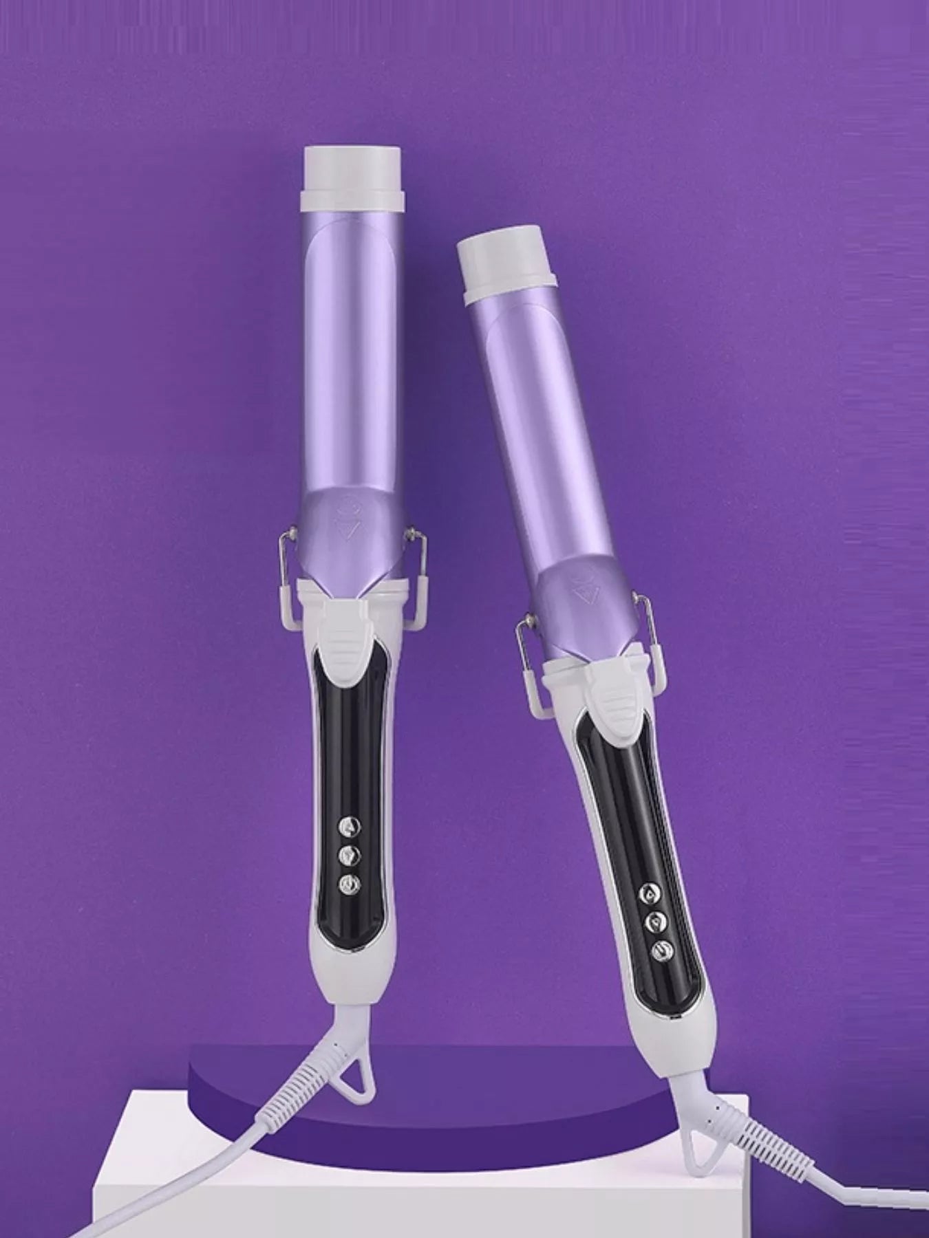 Pair of purple automatic rotating ceramic curling irons with white grips and cords.