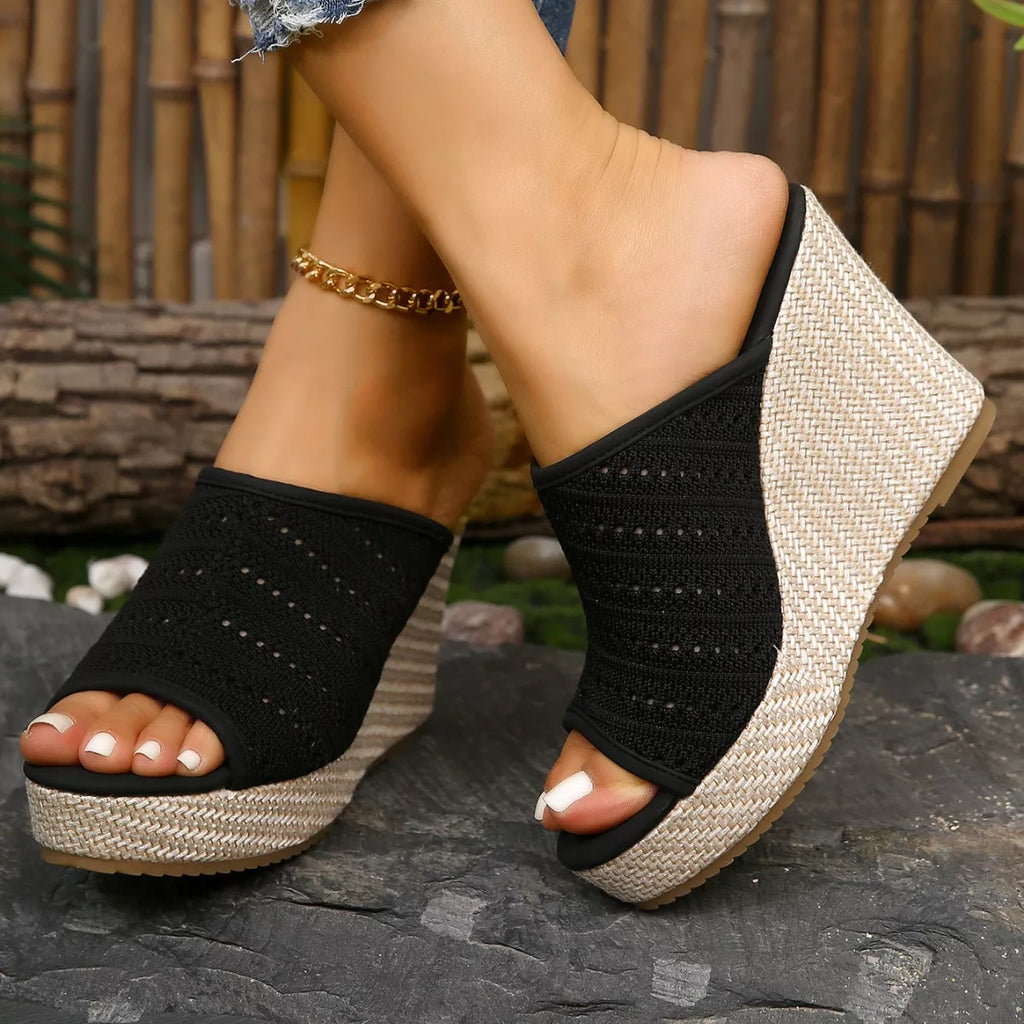 Black open-toe wedge sandals with crisscross knit straps and textured wedge