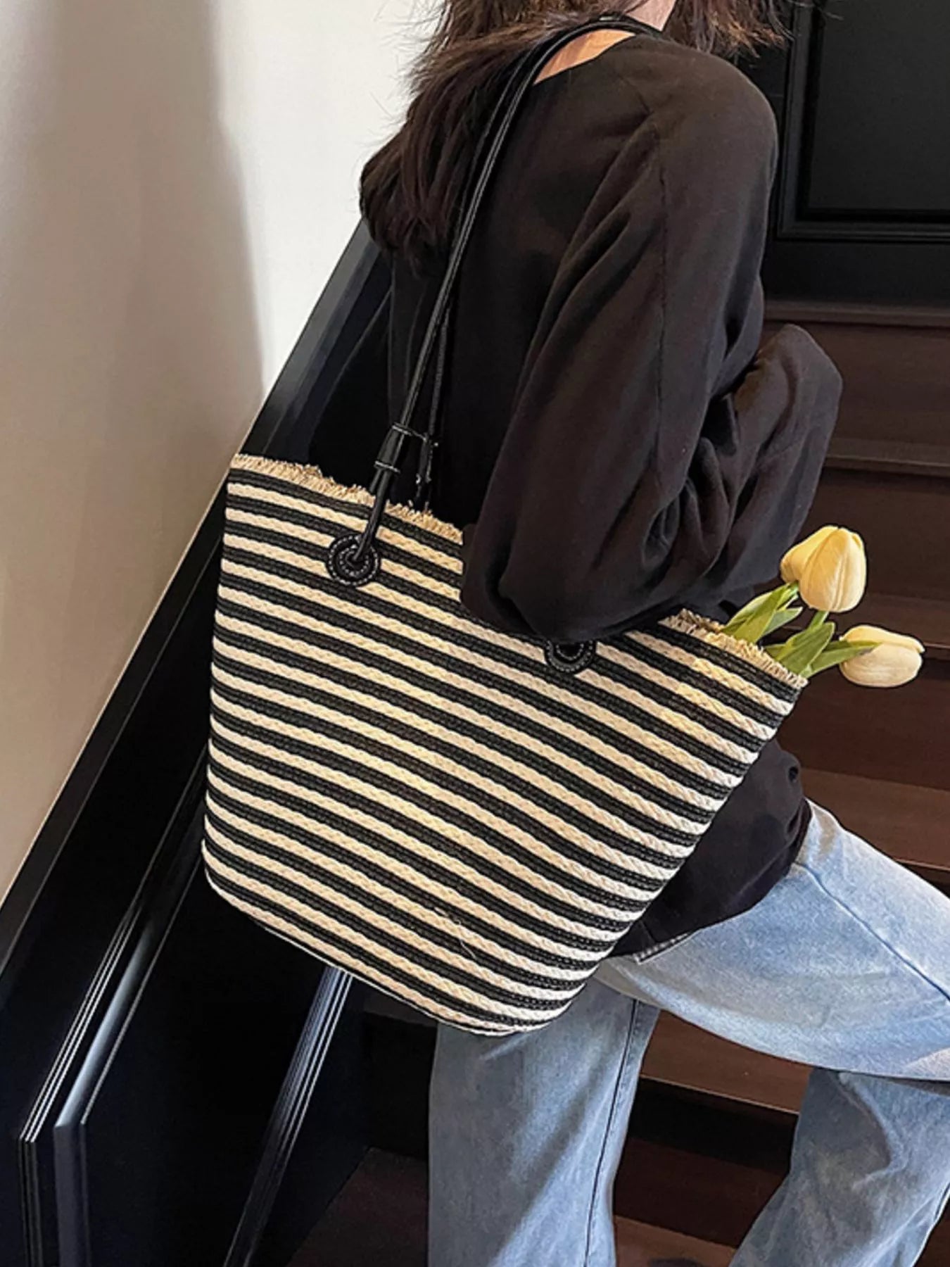 Black striped woven straw shoulder bag with black double ring handles